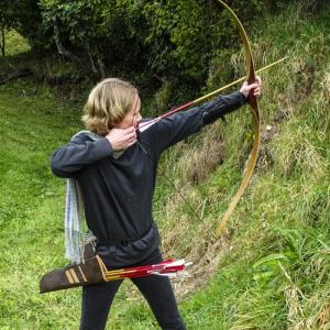 Woman shooting uphill with a longbow