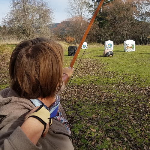 Female Archer Denise shooting her longbow